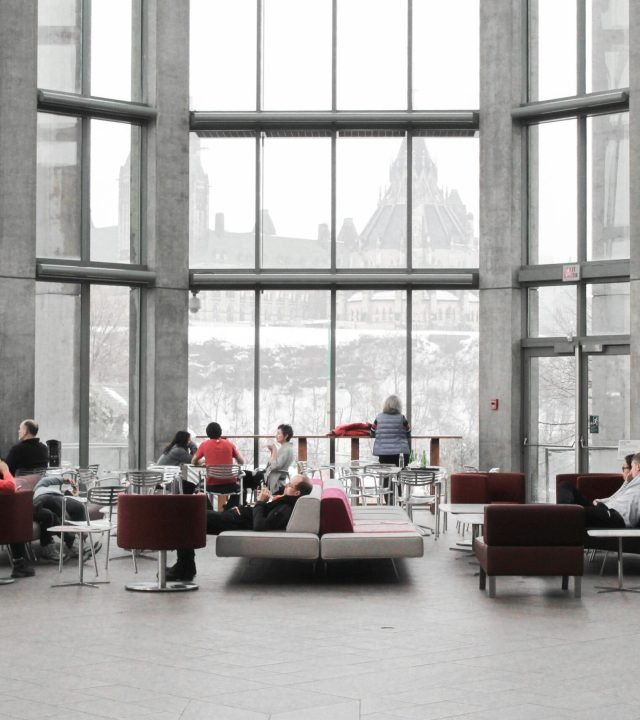 Spacious lounge with modern decor and large windows showcasing a snowy Ottawa view.