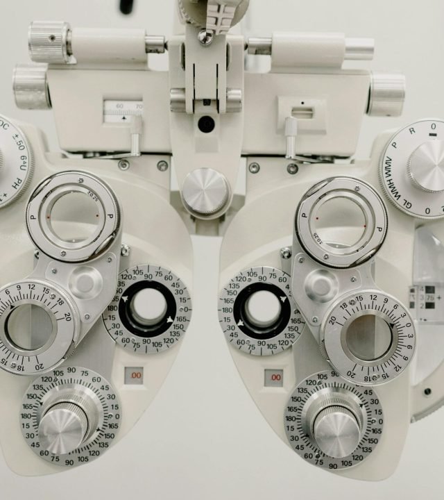 Close-up of a phoropter used in an eye examination in an optometry clinic.